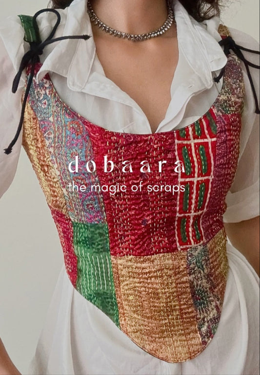 Person wearing a colorful patchwork vest with 'dobaara' branding.